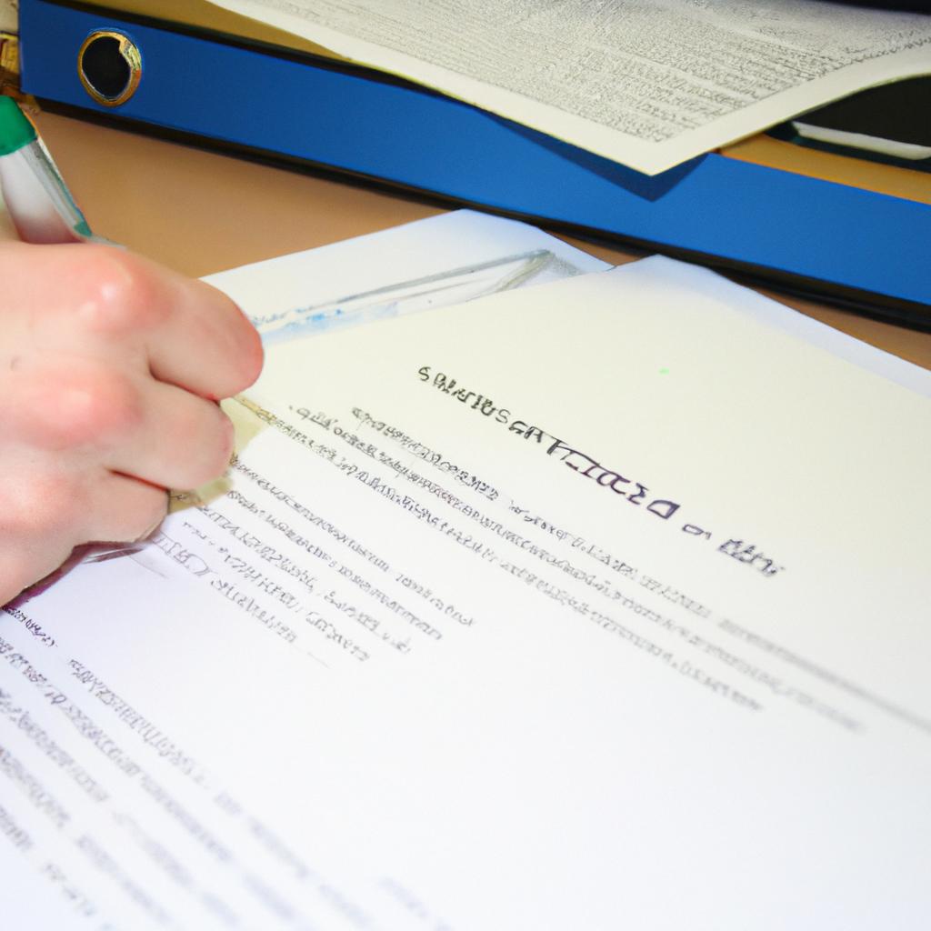 Person signing loan documents at desk